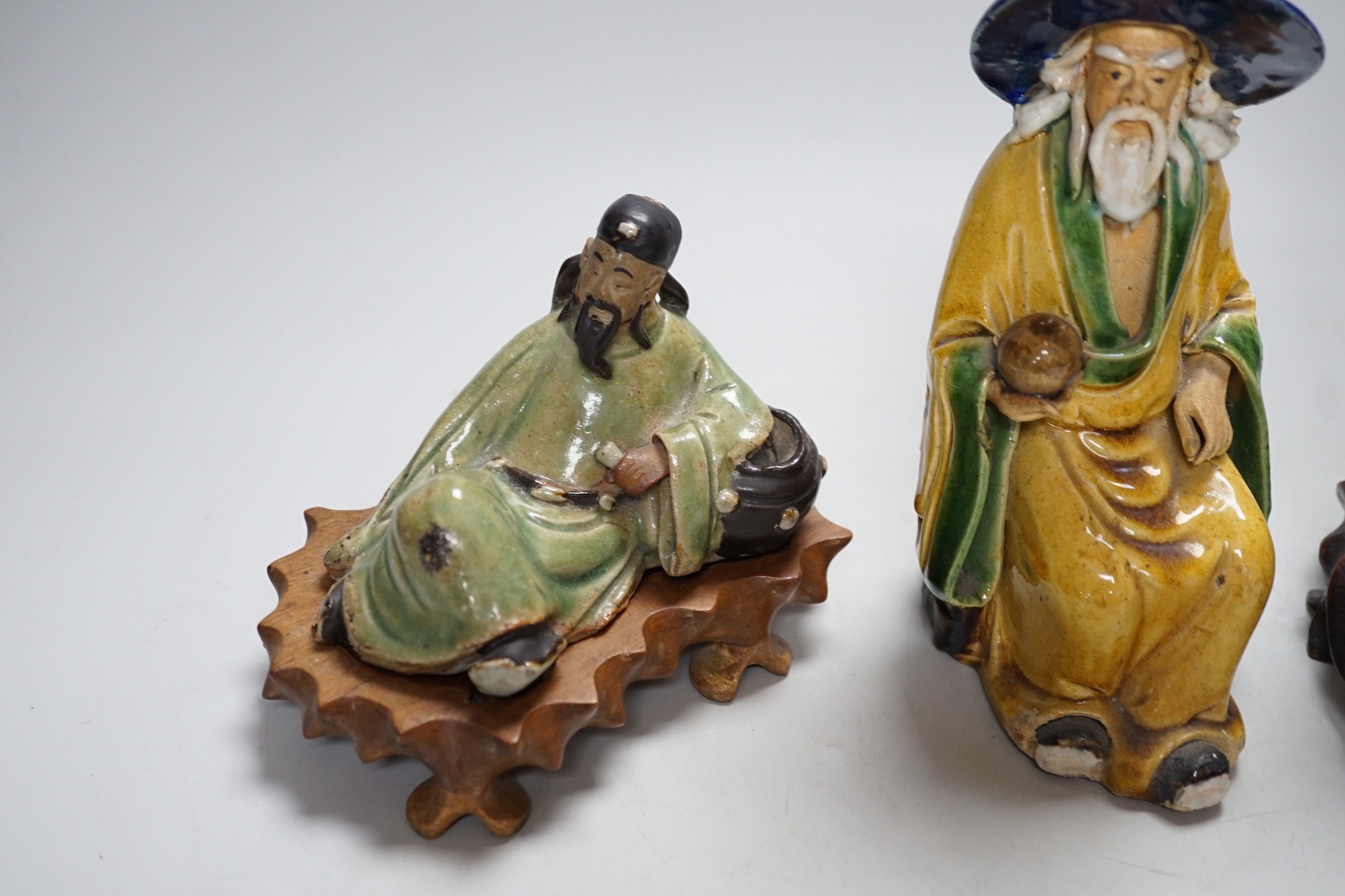 Three Chinese Shiwan pottery figures of an Emperor, Li Bai and an old man, tallest 23cm